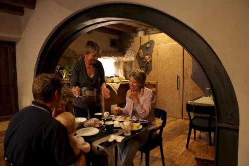 a group of people sitting around a table eating food at Maison Bondaz & SPA privé in Aosta