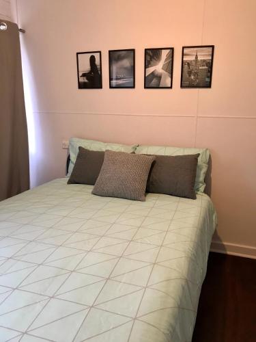 a bedroom with a bed and a painting on the wall at Busselton Backpackers in Busselton