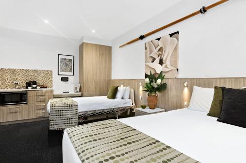 A bed or beds in a room at North Adelaide Boutique Stays Accommodation