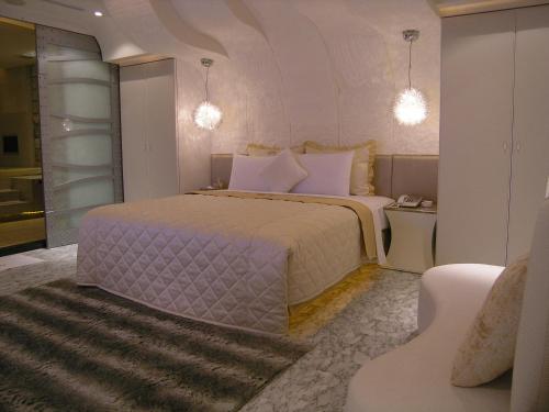 a bedroom with a large bed and a couch at Miho Boutique Motel in Zhonghe