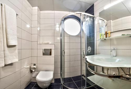 a bathroom with a toilet and a sink at Hotel Perfect in Varna City