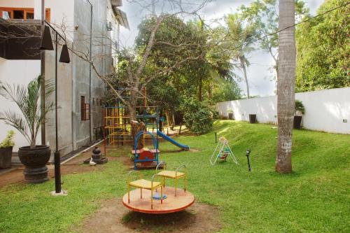 a yard with a playground with a slide at The Triangle Hotel in Anuradhapura