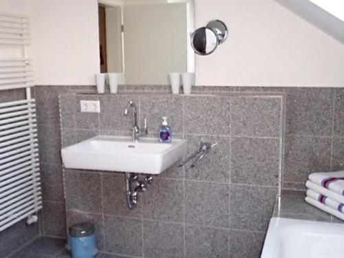 a bathroom with a sink and a mirror at Ferienwohnung Susanne Kiefer in Nonnenhorn