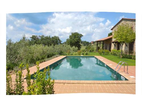 a swimming pool in the yard of a house at Casale Umbro in Castiglione del Lago