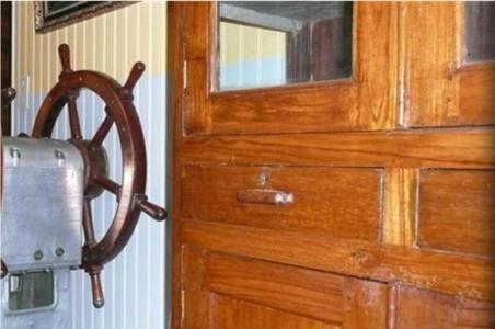 a wooden door with a wooden wheel attached to it at Hôtel Kermor in Concarneau