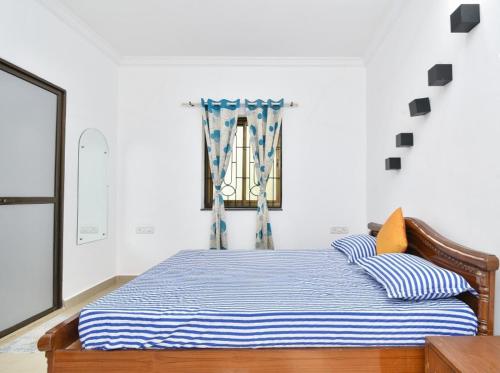 Ένα ή περισσότερα κρεβάτια σε δωμάτιο στο Goaesha Apartment
