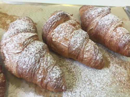 a group of croissants on a pan with powdered sugar at Penzion Ema B&B in Prostějov