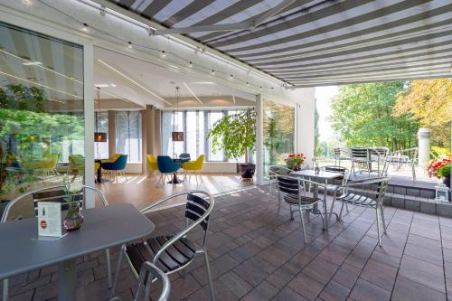 a room with tables and chairs on a patio at Hotel Vivaldi in Poznań