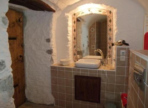 uma casa de banho com um lavatório e um espelho em Le Domaine du Grand Cellier Gîtes Appartement en Savoie em Tournon