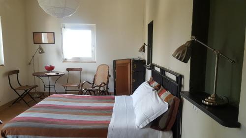 a bedroom with a bed and a table and chairs at Tenuta San Marcello in San Marcello