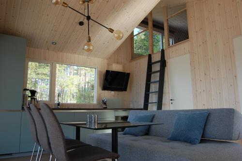 a living room with a table and a couch at Nisser Hyttegrend og Camping in Fjone