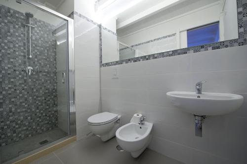 a bathroom with a sink and a toilet and a shower at Casa Bova in Mesagne