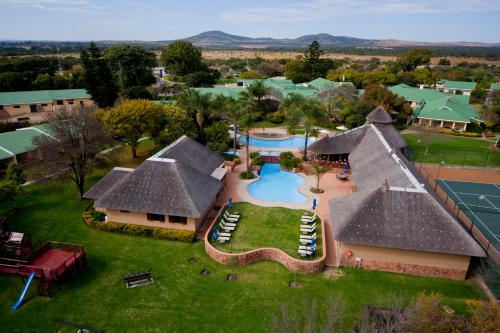 an aerial view of a house with a swimming pool at Protea Hotel by Marriott Polokwane Ranch Resort in Polokwane