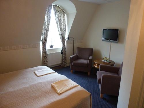 Postel nebo postele na pokoji v ubytování Nya Pallas Hotel