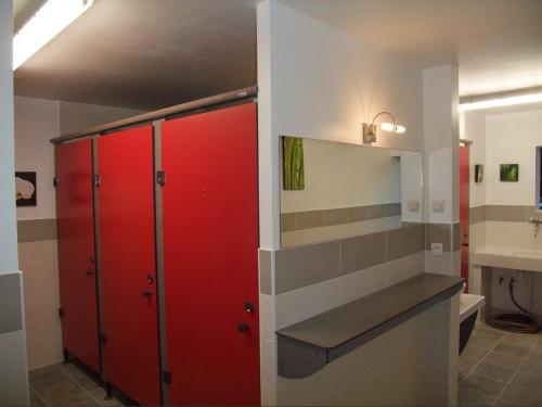 a bathroom with red lockers and a sink at Domaine du Grand Cellier - Insolite en Savoie in Tournon