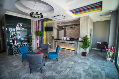 a lobby with a table and chairs and a fireplace at INDRA HOTEL - BOUTIQUE SUITES in Ipoh