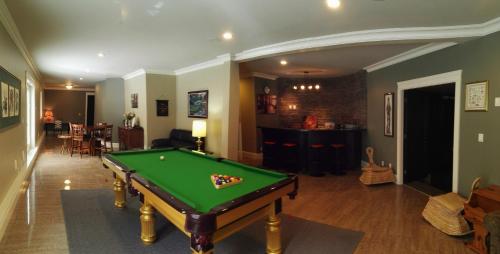 a living room with a pool table in it at Sunny Island by White Rock in White Rock