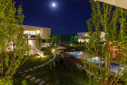 a view of a building with a pool at night at Senderos in Villa Gesell