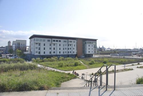 a large building with a staircase in front of it at Auberge de jeunesse L'Escale in Dunkerque