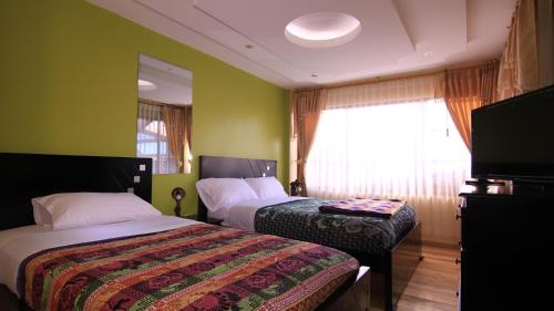 Un pat sau paturi într-o cameră la Kucha Wasi Hosteria
