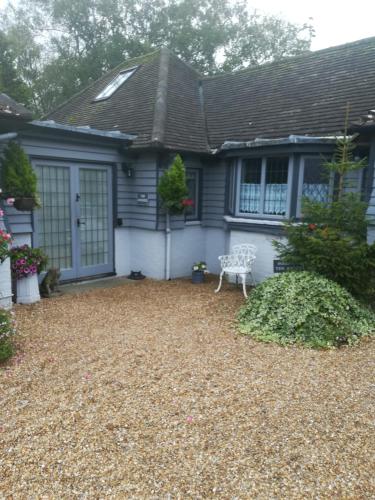 a house with a gravel yard in front of it at The Gate Cottage in West Itchenor