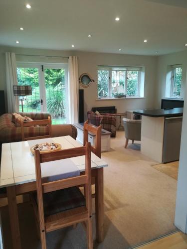 a living room with a couch and a table at The Gate Cottage in West Itchenor