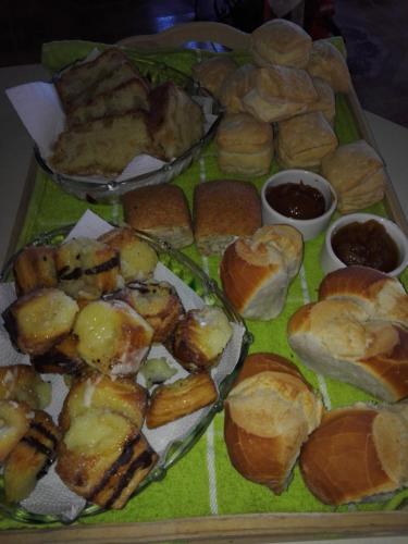 a tray of bread and pastries on a table at Atardecer Serrano in Huerta Grande