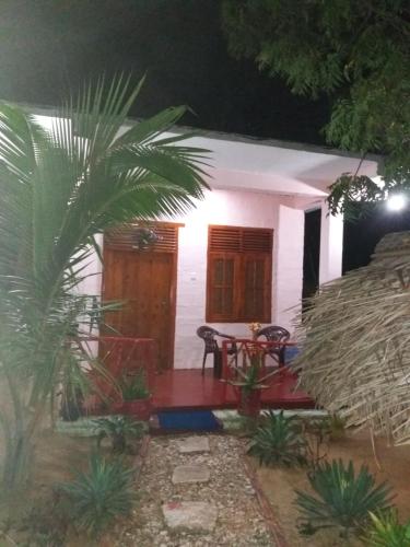 a small white house with a table in front of it at Star Sun Homestay in Tangalle
