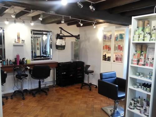 a hair salon with two chairs and a mirror at Mackworth House Farm in Derby
