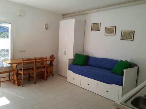 a bedroom with a bed and a table and a dining room at Villa Flora in Grado