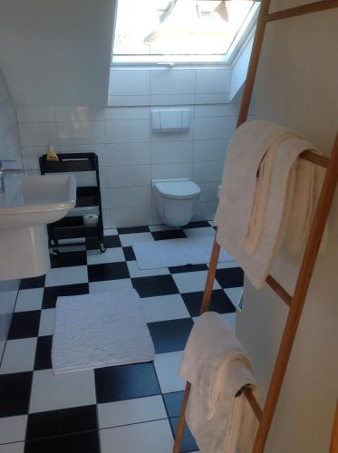 a bathroom with a black and white checkered floor at Kress No.1 in Kehl am Rhein