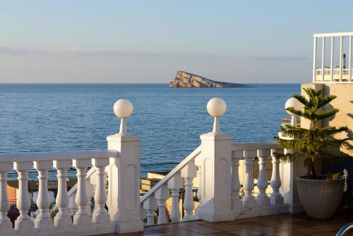a white railing with a view of the ocean at Hotel Avenida in Benidorm
