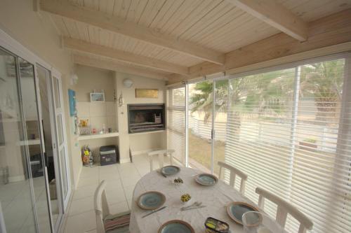 a dining room with a table and a large window at B4 Waterfront in Swakopmund
