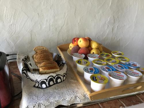 a tray of food with bread and fruit on a table at Villa Kuky in Santa Teresa Gallura
