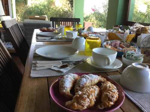 a table with a plate of pastries on it at Villa Kuky in Santa Teresa Gallura