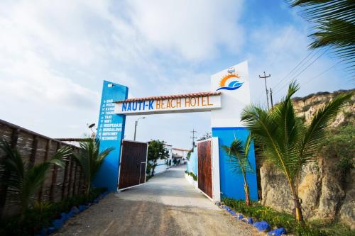 a sign for a hotel on a road at Nauti-k Beach Hotel in Tumbes