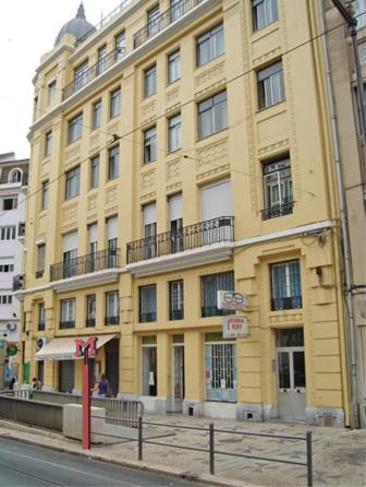 a large yellow building on the corner of a street at Residencial Roxi in Lisbon