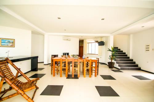a room with a table and chairs and stairs at Nauti-k Beach Hotel in Tumbes