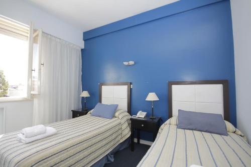 Una cama o camas en una habitación de Hotel Libertador de Pinamar