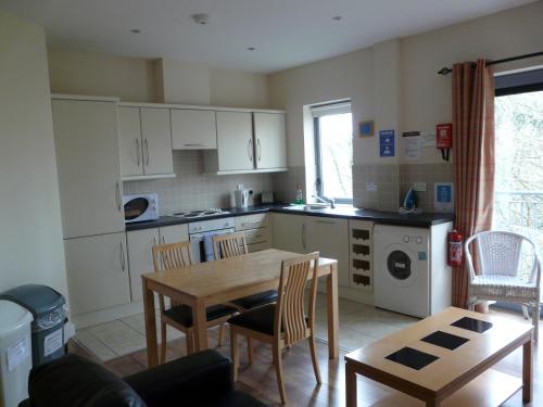 a kitchen with a table and a table and chairs at The Courtyard Apartments in Carrick on Shannon