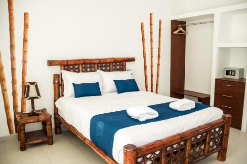 a bedroom with a large bed with towels on it at Nauti-k Beach Hotel in Tumbes