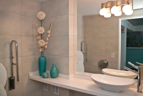 a bathroom with two sinks and a mirror at ian Hotel in Buenos Aires