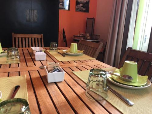 a wooden table with green dishes on top of it at CAFFELETTI friendly B&B in Torre del Lago Puccini