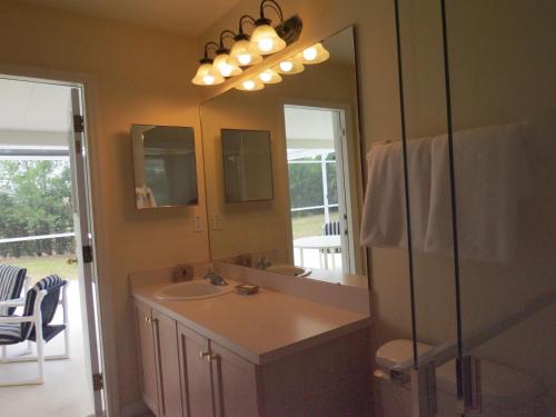 a bathroom with a sink and a mirror at Westridge Pool Home in Davenport