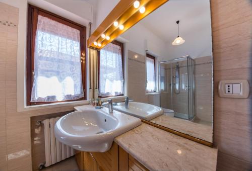 a bathroom with two sinks and a shower at La Castellese in Aci Castello