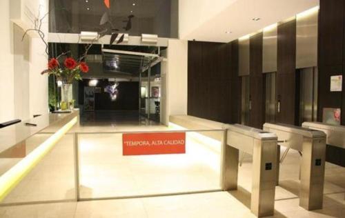 a lobby with a red sign in a building at Monoambiente Frente Al Hospital Italiano in Buenos Aires