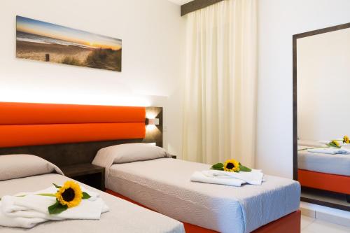 Ένα ή περισσότερα κρεβάτια σε δωμάτιο στο Residence Perla Verde