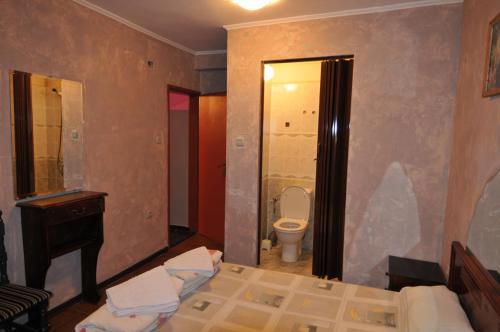 a bathroom with a bed and a toilet and a sink at Snow Heaven Hotel in Bankya
