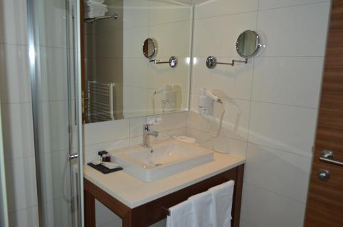 a bathroom with a sink and a shower at Apartments B&P in Jahorina