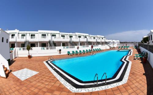 a large swimming pool in the middle of a building at Apartamentos Tisalaya in Puerto del Carmen